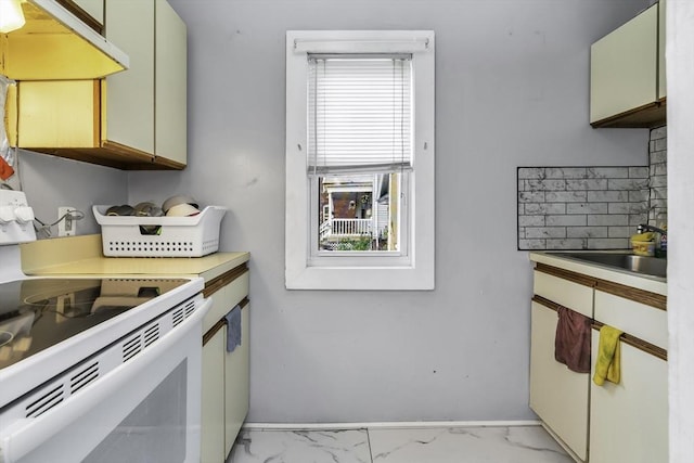 77-79 Grenada Ter, Springfield, MA 01108 - kitchen with under cabinet range hood, white electric range oven, a sink, and plenty of natural light