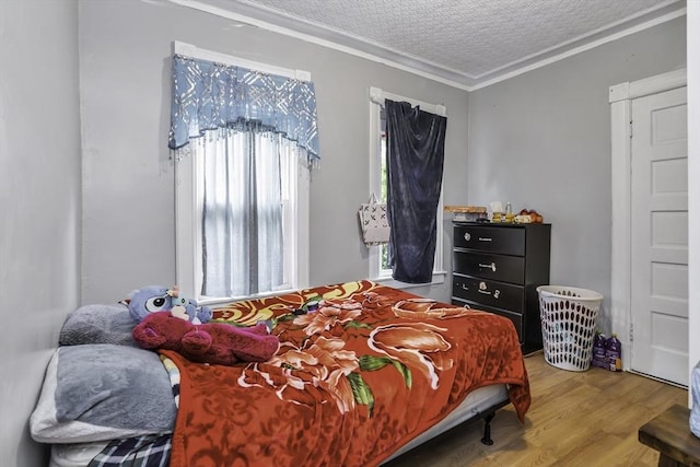 77-79 Grenada Ter, Springfield, MA 01108 - bedroom featuring wood finished floors, a textured ceiling, and crown molding