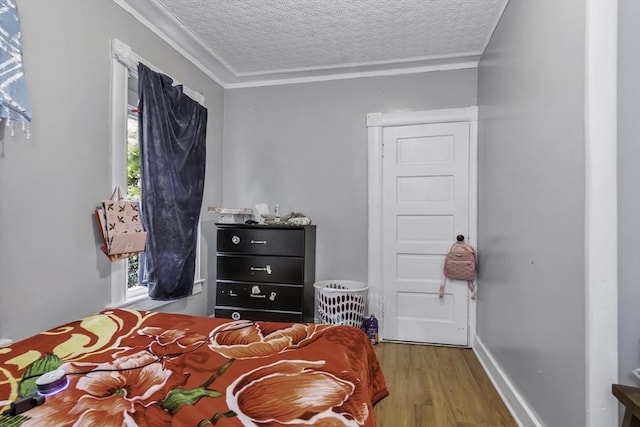 77-79 Grenada Ter, Springfield, MA 01108 - bedroom with wood finished floors, ornamental molding, and a textured ceiling