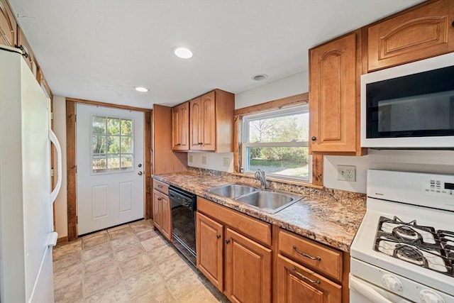 kitchen with white appliances, a sink, recessed lighting, and brown cabinets