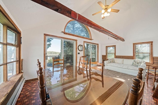 bedroom with a baseboard heating unit and multiple windows