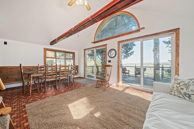 living area featuring beam ceiling, ceiling fan, high vaulted ceiling, baseboard heating, and baseboards