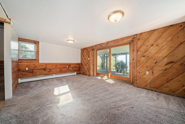 bonus room featuring a baseboard radiator, wooden walls, and carpet floors