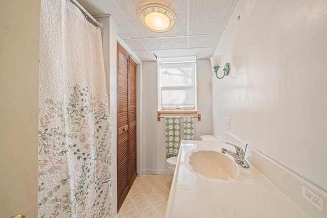 bathroom with toilet, a closet, vanity, and curtained shower