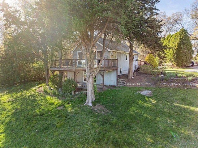 view of grassy yard featuring a wooden deck