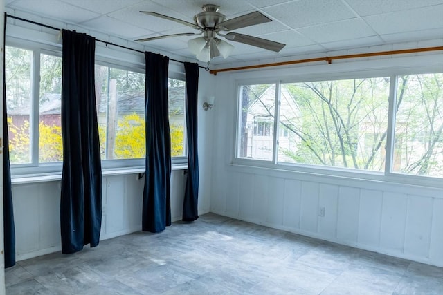 spare room featuring a drop ceiling and a ceiling fan