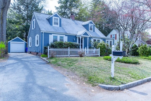 new england style home with an outbuilding, a chimney, a detached garage, fence, and driveway
