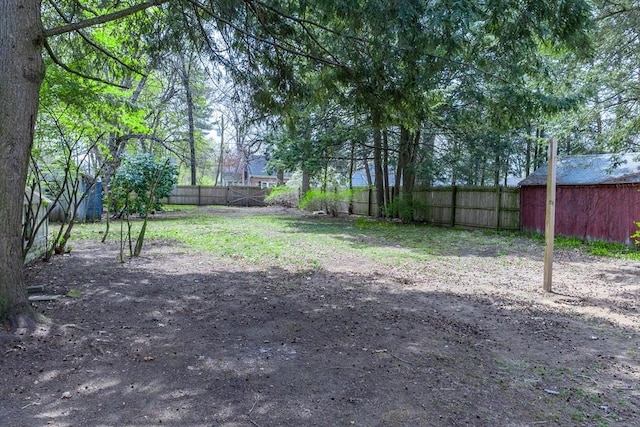 fenced backyard with an outbuilding