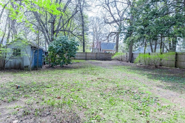 fenced backyard featuring an outbuilding and a storage unit