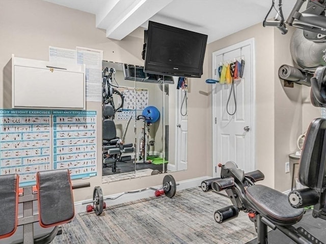 workout room featuring baseboards