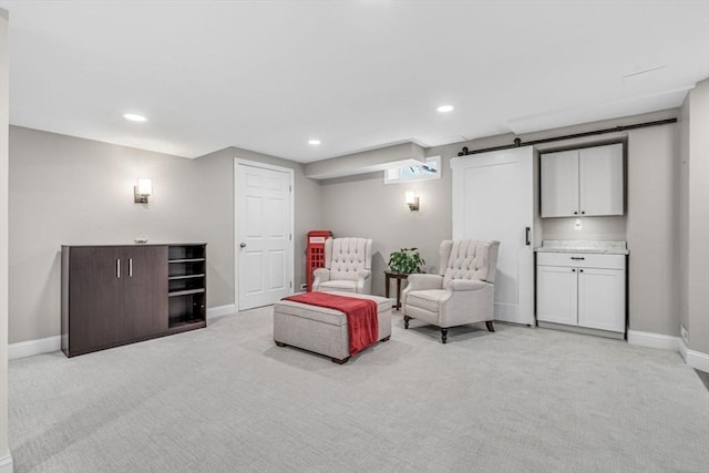 living area featuring recessed lighting, light carpet, and baseboards