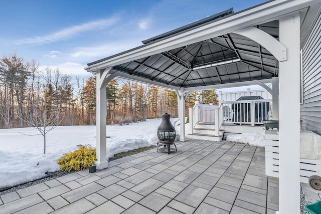 snow covered patio featuring a gazebo