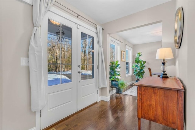 entryway with french doors, dark wood finished floors, and baseboards