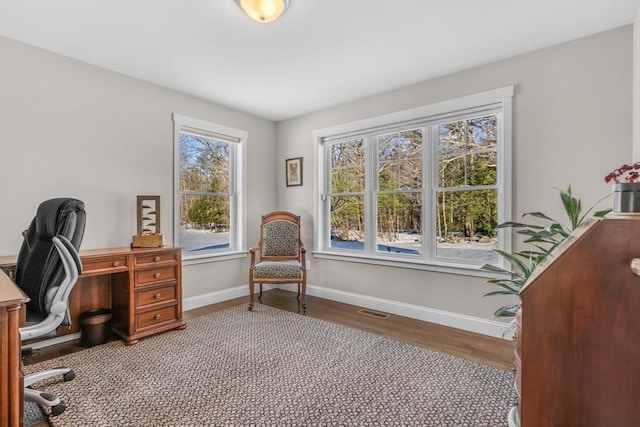 office with visible vents, baseboards, and wood finished floors