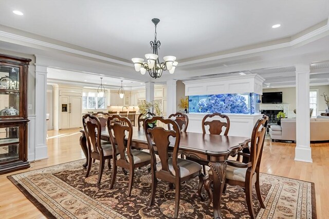42 Westerly Rd, Weston, MA 02493 - dining room with a chandelier, decorative columns, light wood finished floors, crown molding, and plenty of natural light