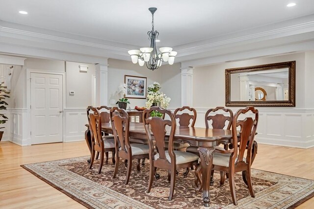 42 Westerly Rd, Weston, MA 02493 - dining space with a decorative wall, decorative columns, light wood-type flooring, a chandelier, and a wainscoted wall