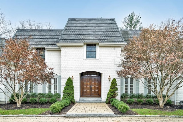 42 Westerly Rd, Weston, MA 02493 - property entrance with a high end roof, brick siding, and mansard roof