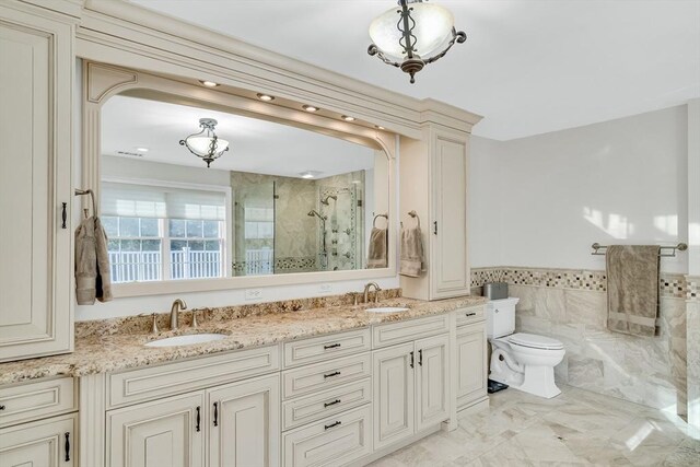 42 Westerly Rd, Weston, MA 02493 - bathroom with a shower stall, double vanity, tile walls, wainscoting, and toilet
