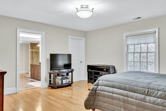 42 Westerly Rd, Weston, MA 02493 - bedroom featuring light wood-style flooring, baseboards, and connected bathroom