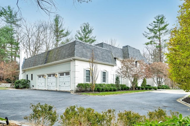 42 Westerly Rd, Weston, MA 02493 - view of building exterior with driveway and a garage