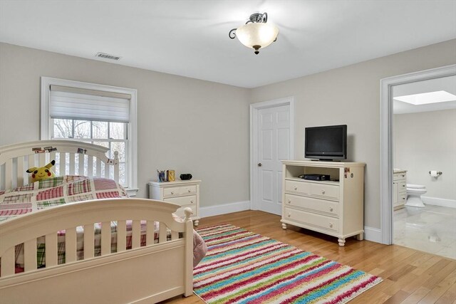 42 Westerly Rd, Weston, MA 02493 - bedroom featuring light wood finished floors, baseboards, and connected bathroom