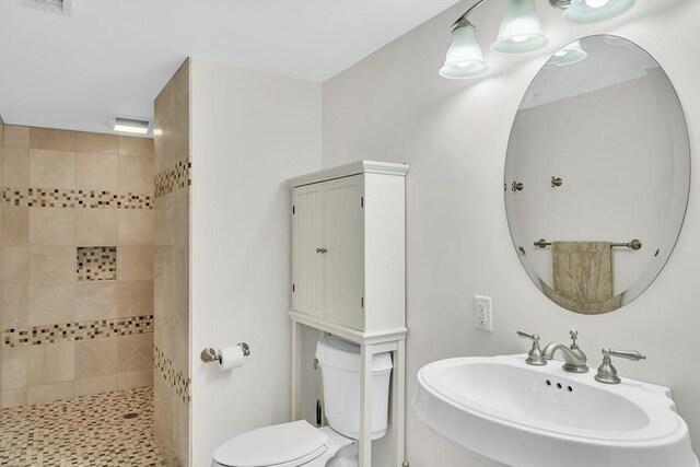 42 Westerly Rd, Weston, MA 02493 - bathroom featuring a sink, a tile shower, and toilet