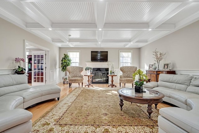 42 Westerly Rd, Weston, MA 02493 - living area featuring light wood-type flooring, beam ceiling, plenty of natural light, a decorative wall, and coffered ceiling