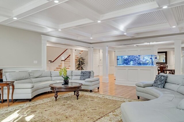 42 Westerly Rd, Weston, MA 02493 - living room with ornate columns, a decorative wall, coffered ceiling, beam ceiling, and light wood finished floors