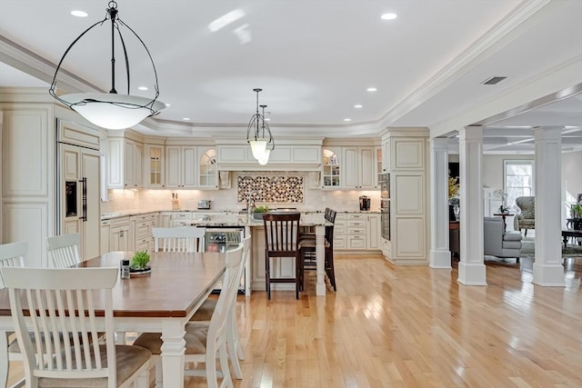 42 Westerly Rd, Weston, MA 02493 - dining room featuring decorative columns, light wood-type flooring, ornamental molding, and recessed lighting