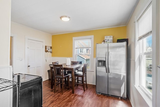 kitchen featuring ornamental molding, stainless steel refrigerator with ice dispenser, baseboards, and dark wood-style flooring