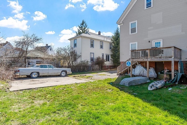 view of yard with fence, stairs, and a deck