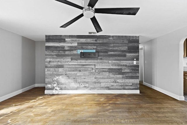 unfurnished living room with ceiling fan and hardwood / wood-style flooring