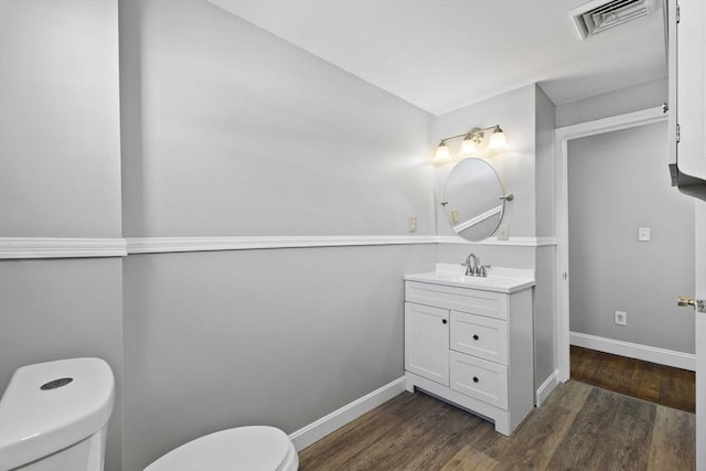 bathroom featuring vanity, toilet, and wood-type flooring