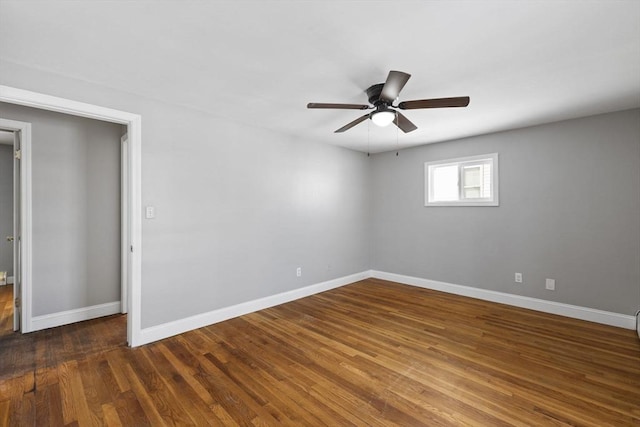 unfurnished room with ceiling fan and dark hardwood / wood-style flooring