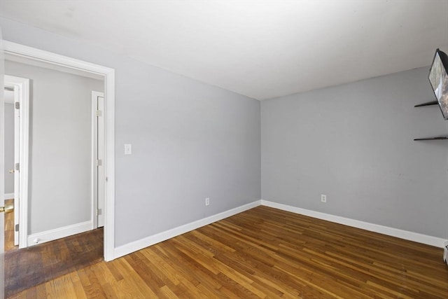 empty room featuring hardwood / wood-style flooring