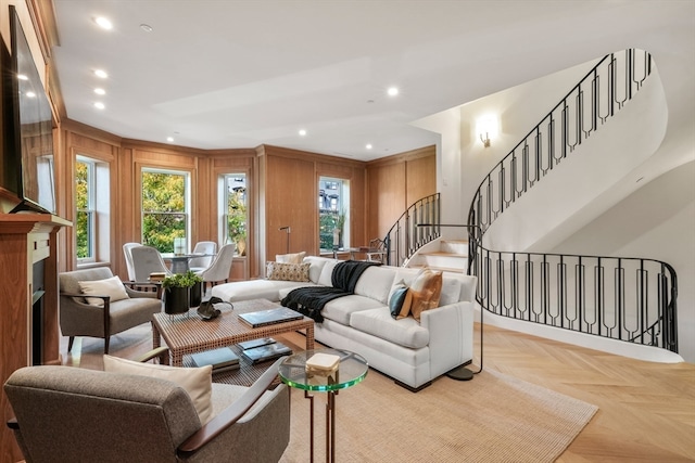 living room with wooden walls and light parquet flooring