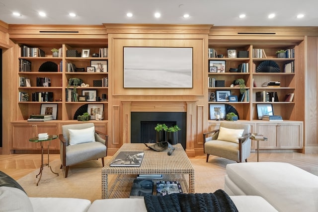 living area featuring built in shelves and wood walls