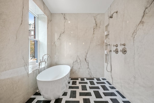 bathroom with plenty of natural light, shower with separate bathtub, and tile walls