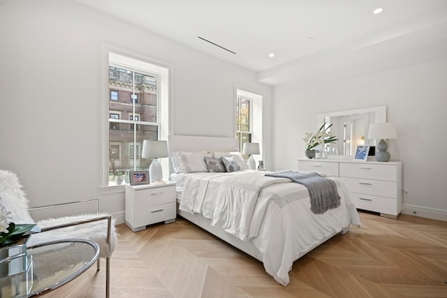 bedroom with light parquet flooring