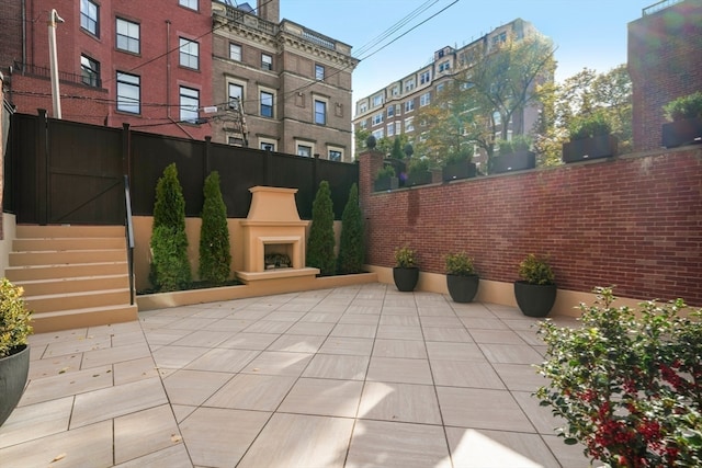 view of patio / terrace featuring an outdoor fireplace