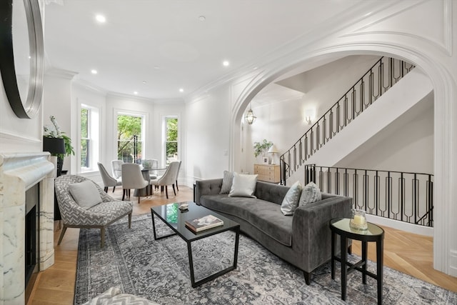 living room with crown molding and parquet floors