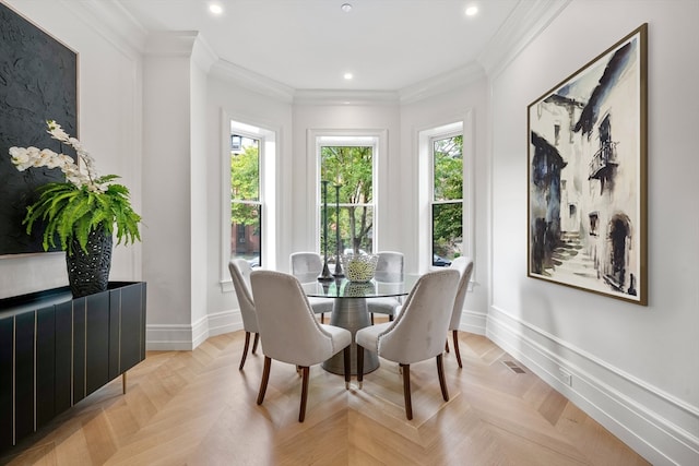 dining space featuring crown molding, light parquet floors, and a wealth of natural light