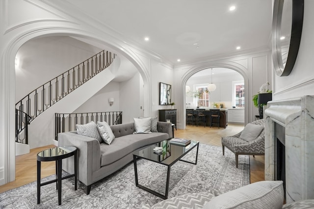 living room with ornamental molding and light parquet floors