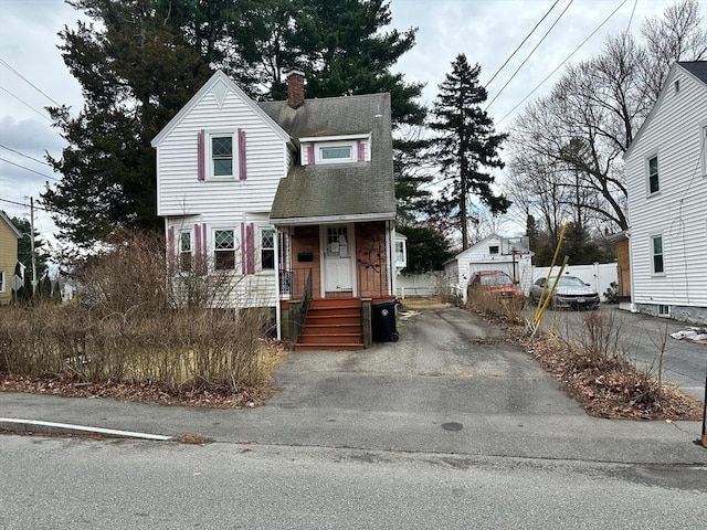 2 Water St, Stoughton, MA 02072 - view of front of house with roof with shingles, fence, and a chimney