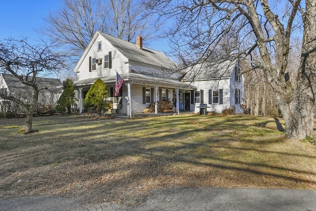 view of front of house with a porch and a front lawn