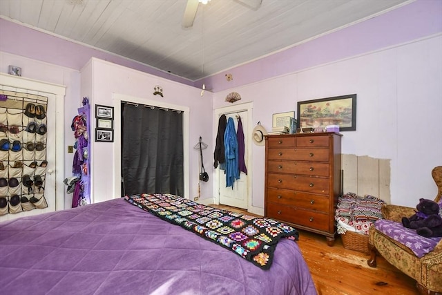 bedroom featuring wood-type flooring, a closet, and ceiling fan