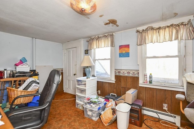 carpeted office featuring wooden walls and a baseboard heating unit