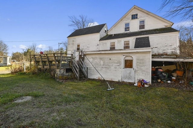 rear view of property with a deck and a yard