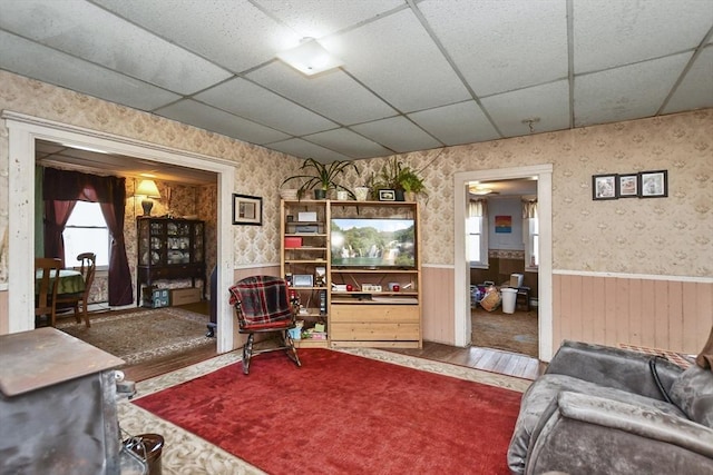 living room with a paneled ceiling and hardwood / wood-style floors