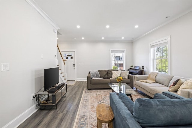 living area featuring crown molding, baseboards, dark wood-style floors, and stairway